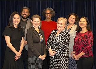 Seven school board members pose for a photo together